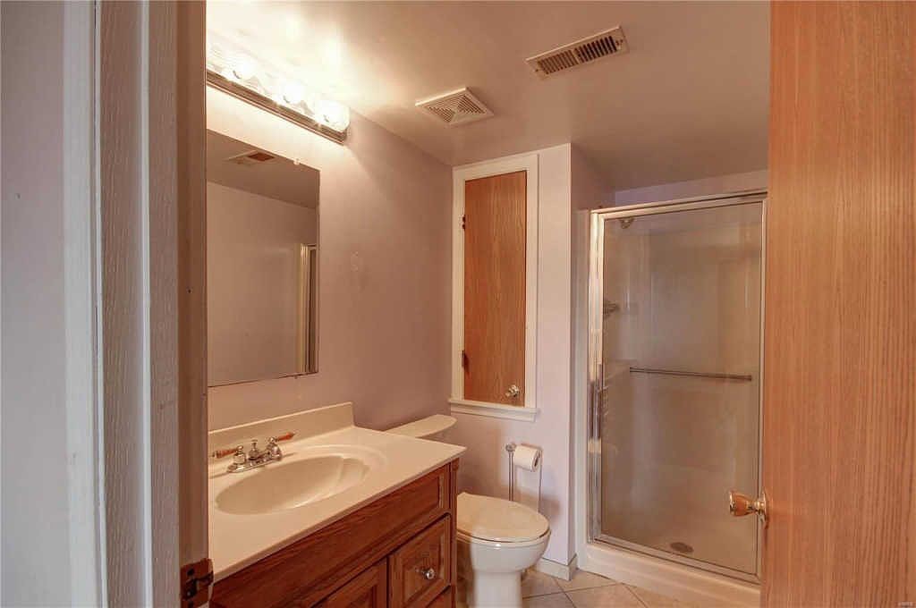 Full bath with walk-in shower and linen cabinet