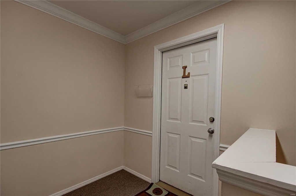 Unit L entry door in the building hallway
